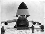 Snowplow being unloaded from an airplane by The Buffalo Courier-Express Newspaper
