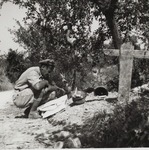 Captain Edward Komolibus Studying a Map at a Forgotten German Grave